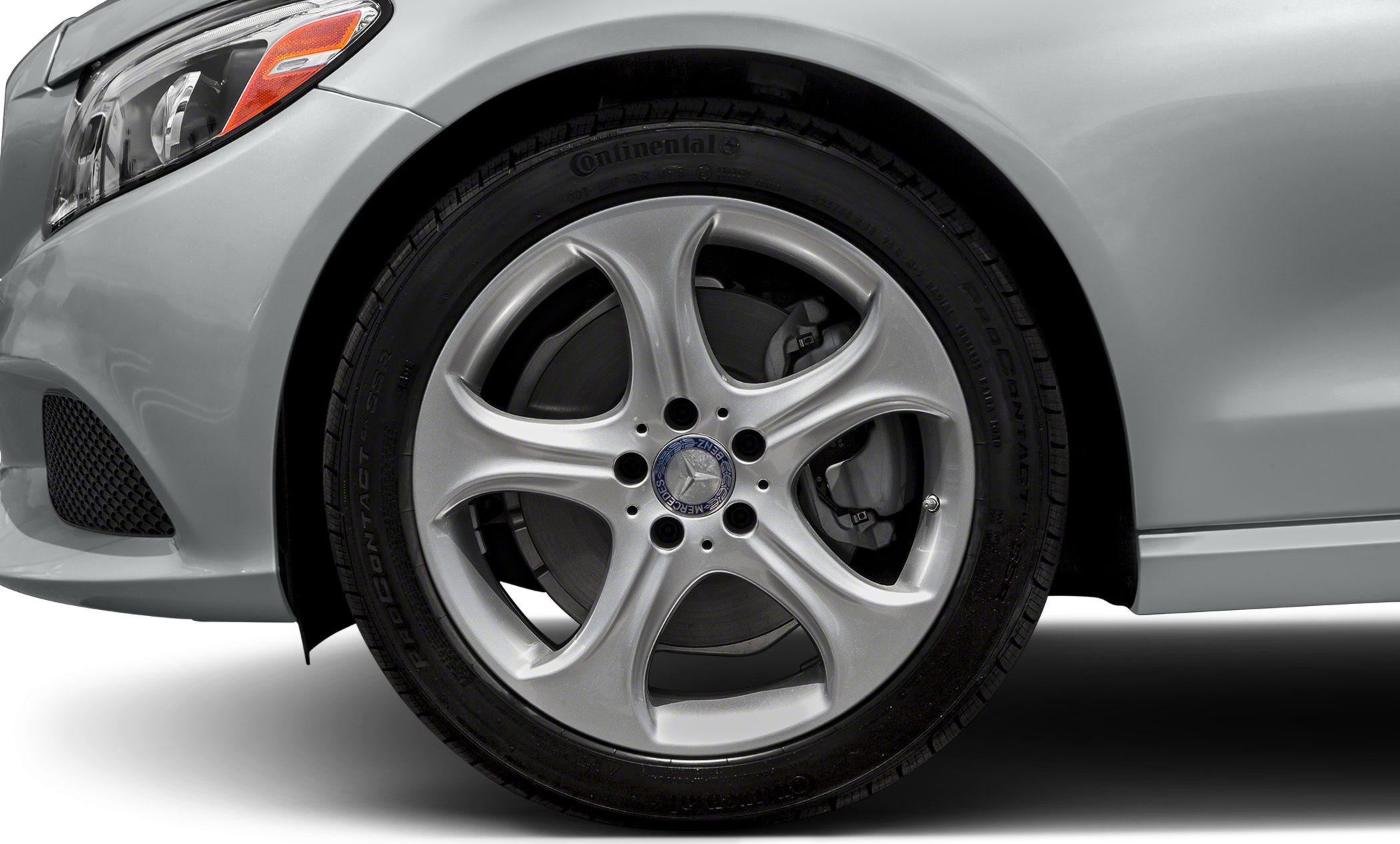 Front alloy wheel and brake disc with Continental tire on car front fender