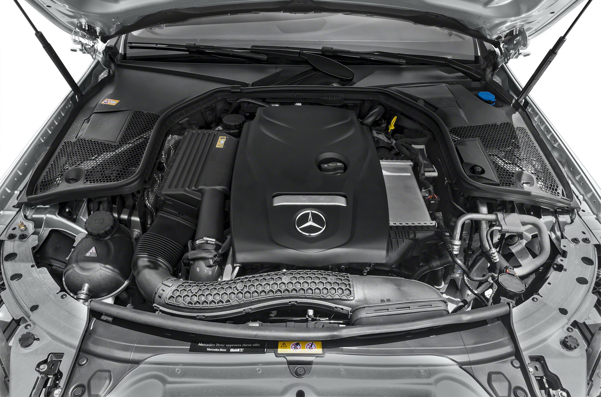 Engine bay with prominent Mercedes-Benz branded engine cover and structured air intake