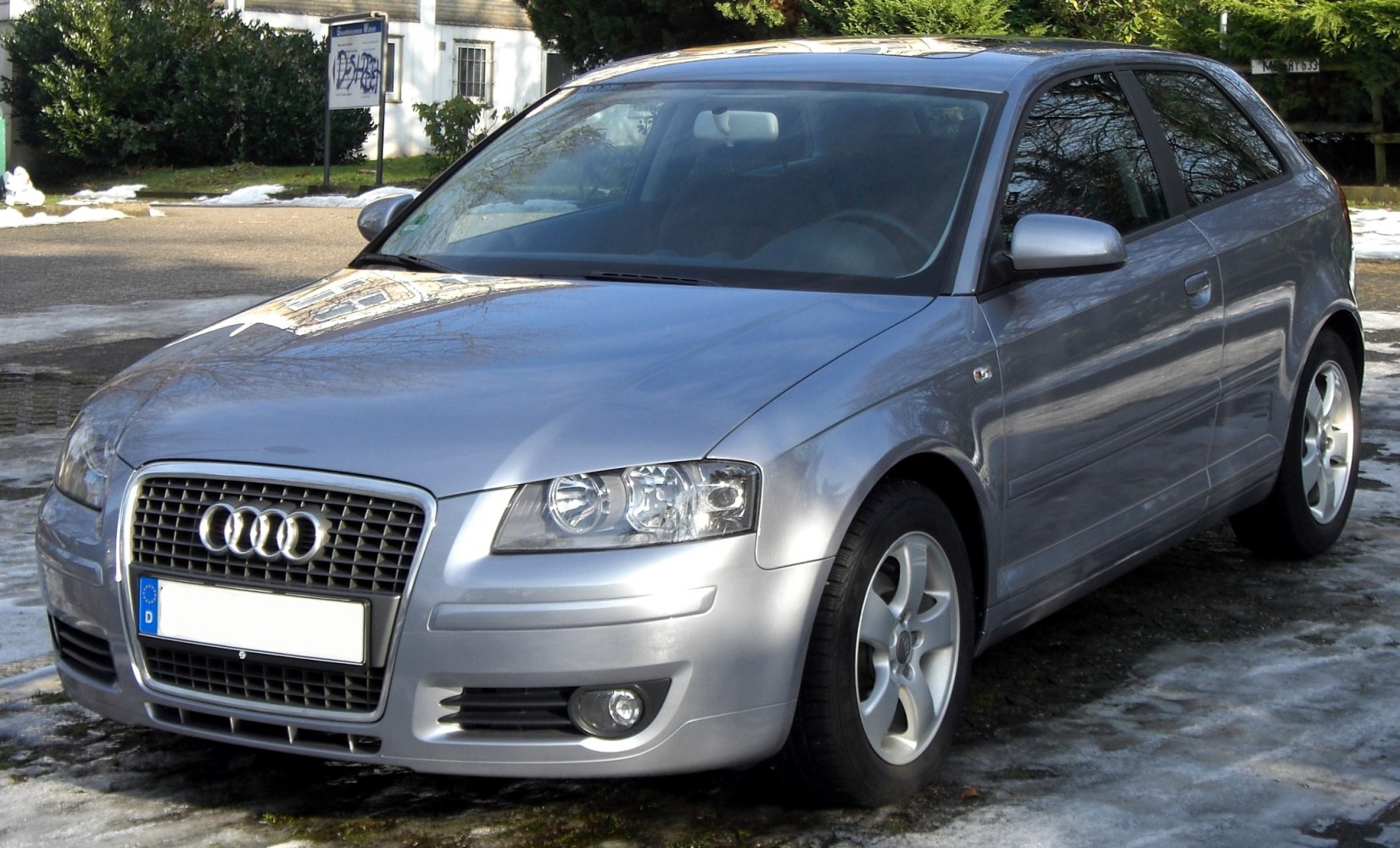Silver compact 3-door hatchback with chrome grille and alloy wheels