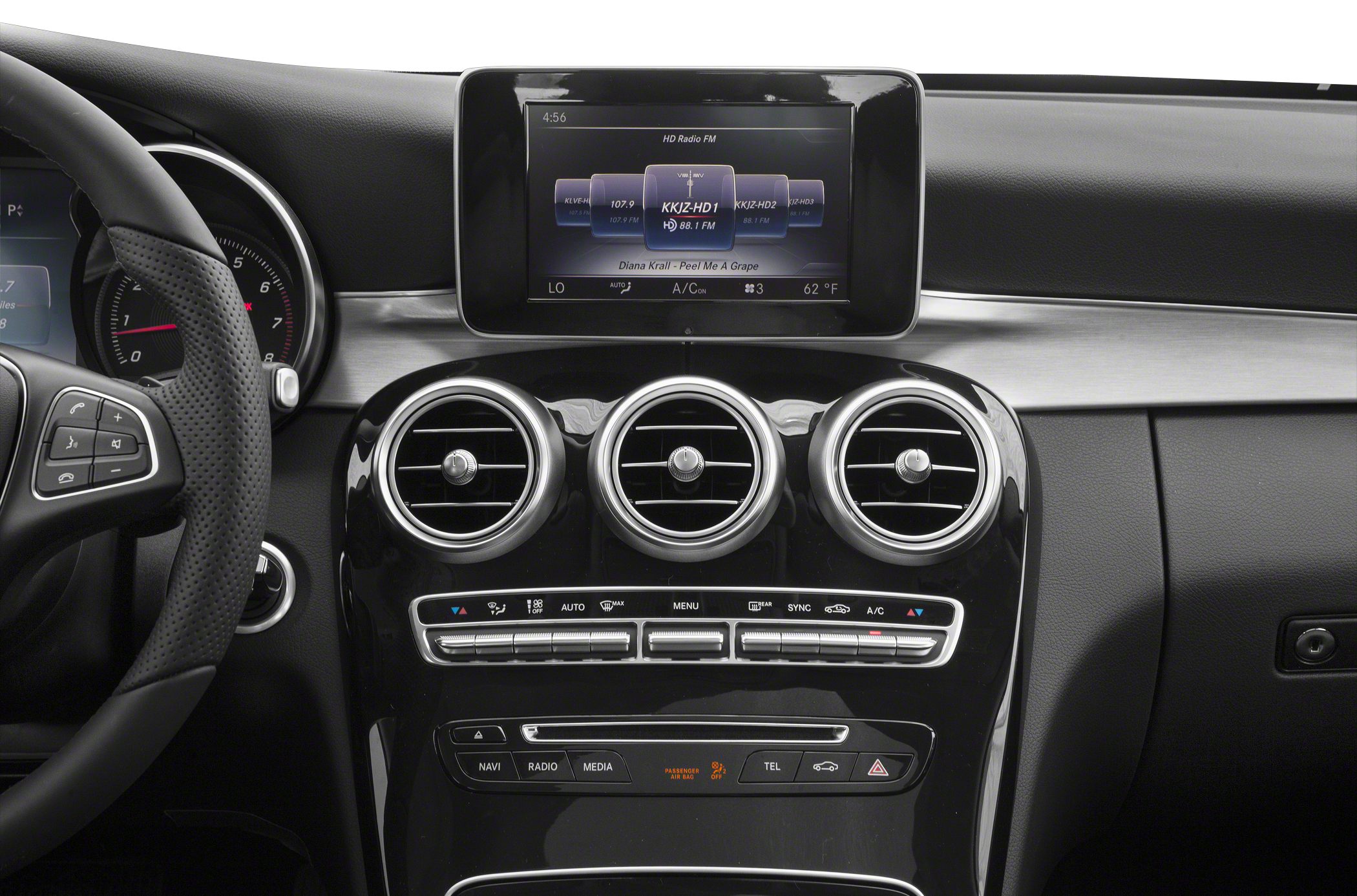 Circular air vents, digital infotainment display, and climate control panel