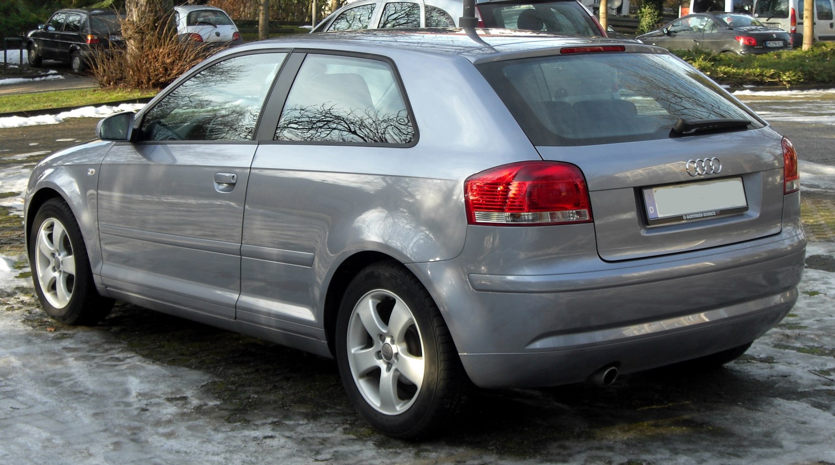 Rear side view of a three-door hatchback with alloy wheels.