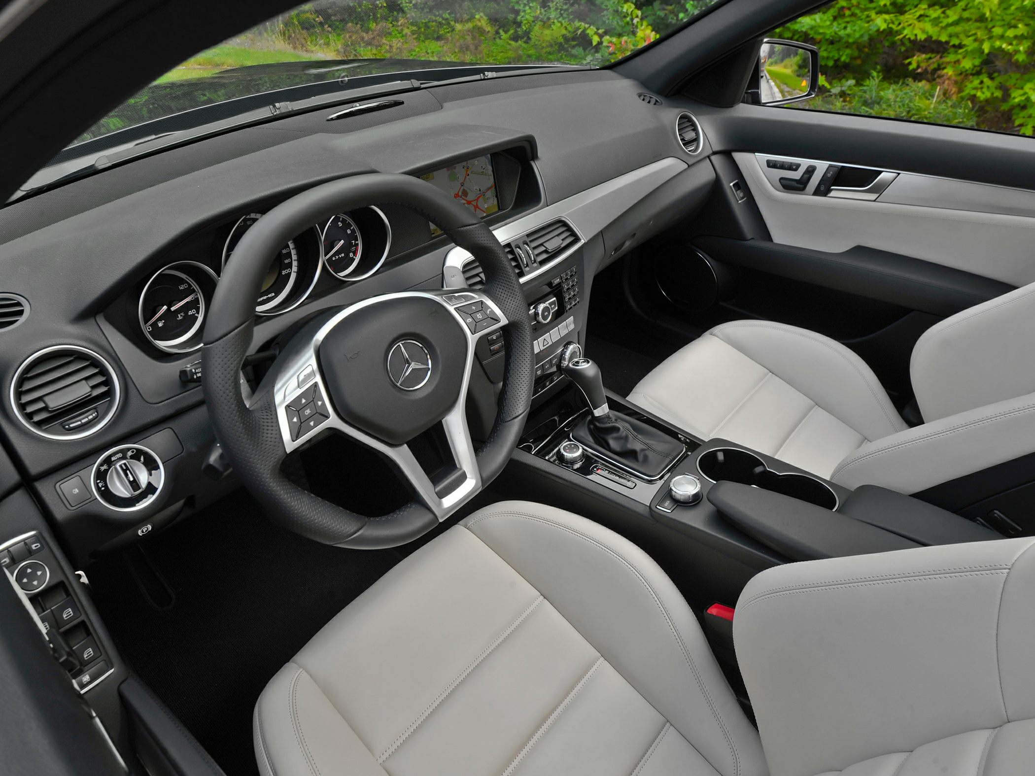 Luxurious interior featuring dashboard, steering wheel, and premium leather seats