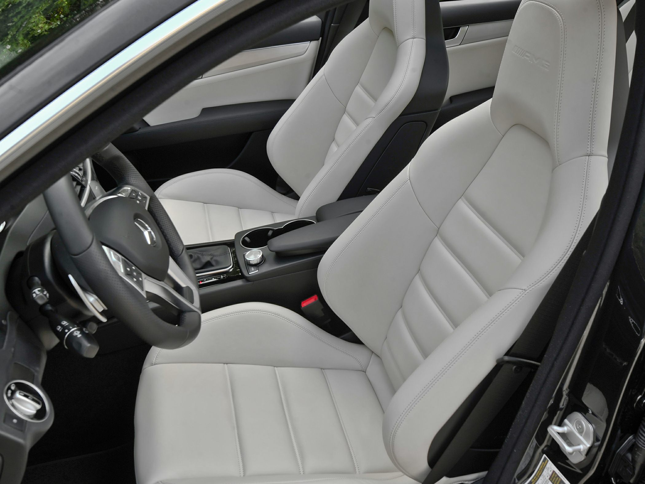 White leather sports seats and center console with steering wheel