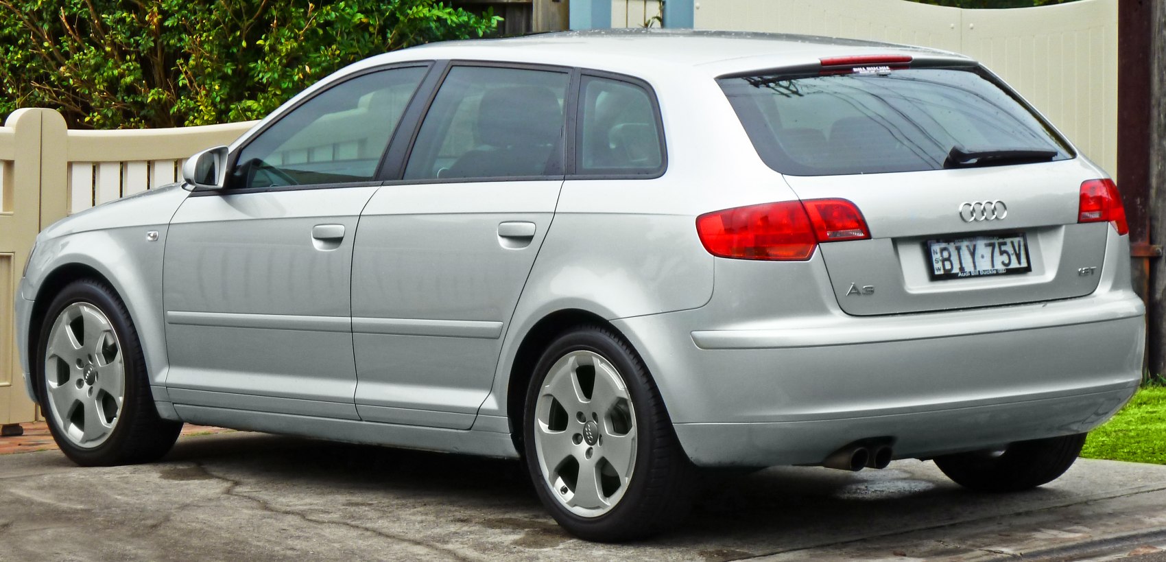 Silver 5-door hatchback rear and side view with alloy wheels and red taillights
