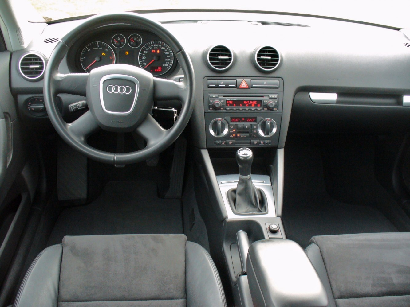 Manual gearshift and dashboard with round air vents