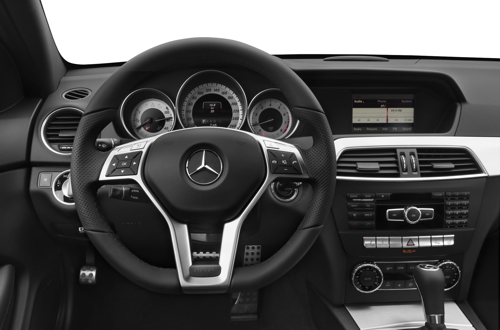 Dashboard with steering wheel, analog gauges, infotainment, and control panel