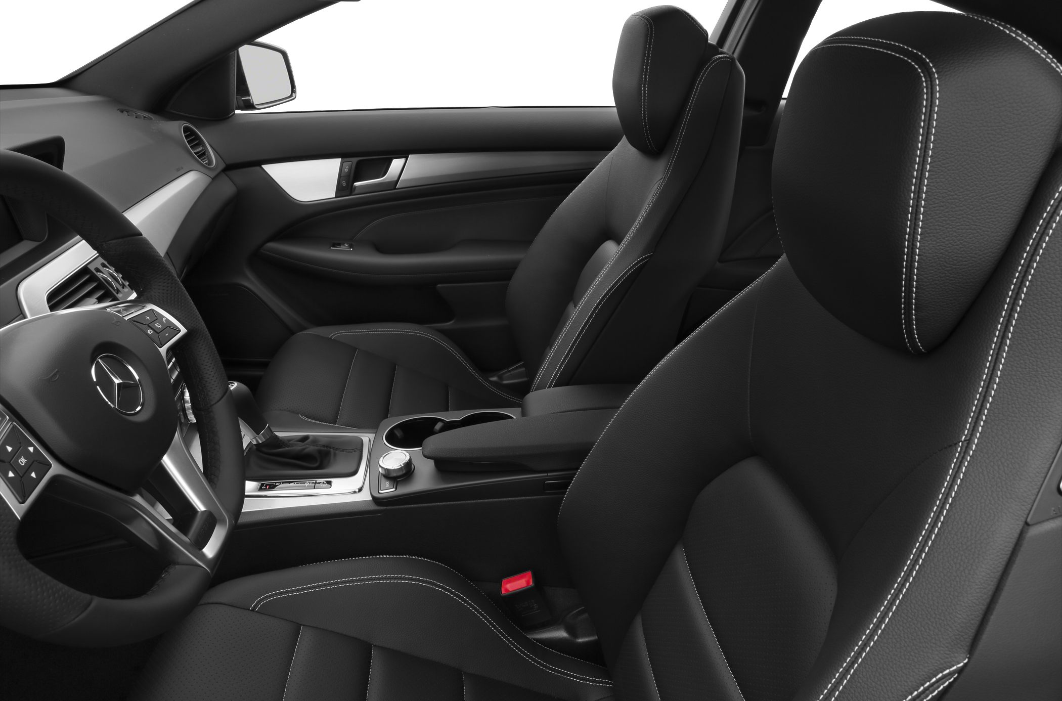 Black leather seats with white stitching and modern dashboard controls.
