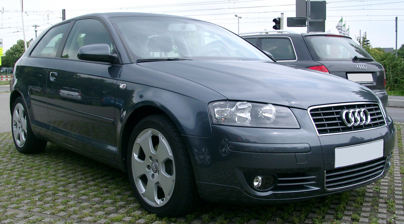 Front-side view of 3-door hatchback with distinct headlights and grille
