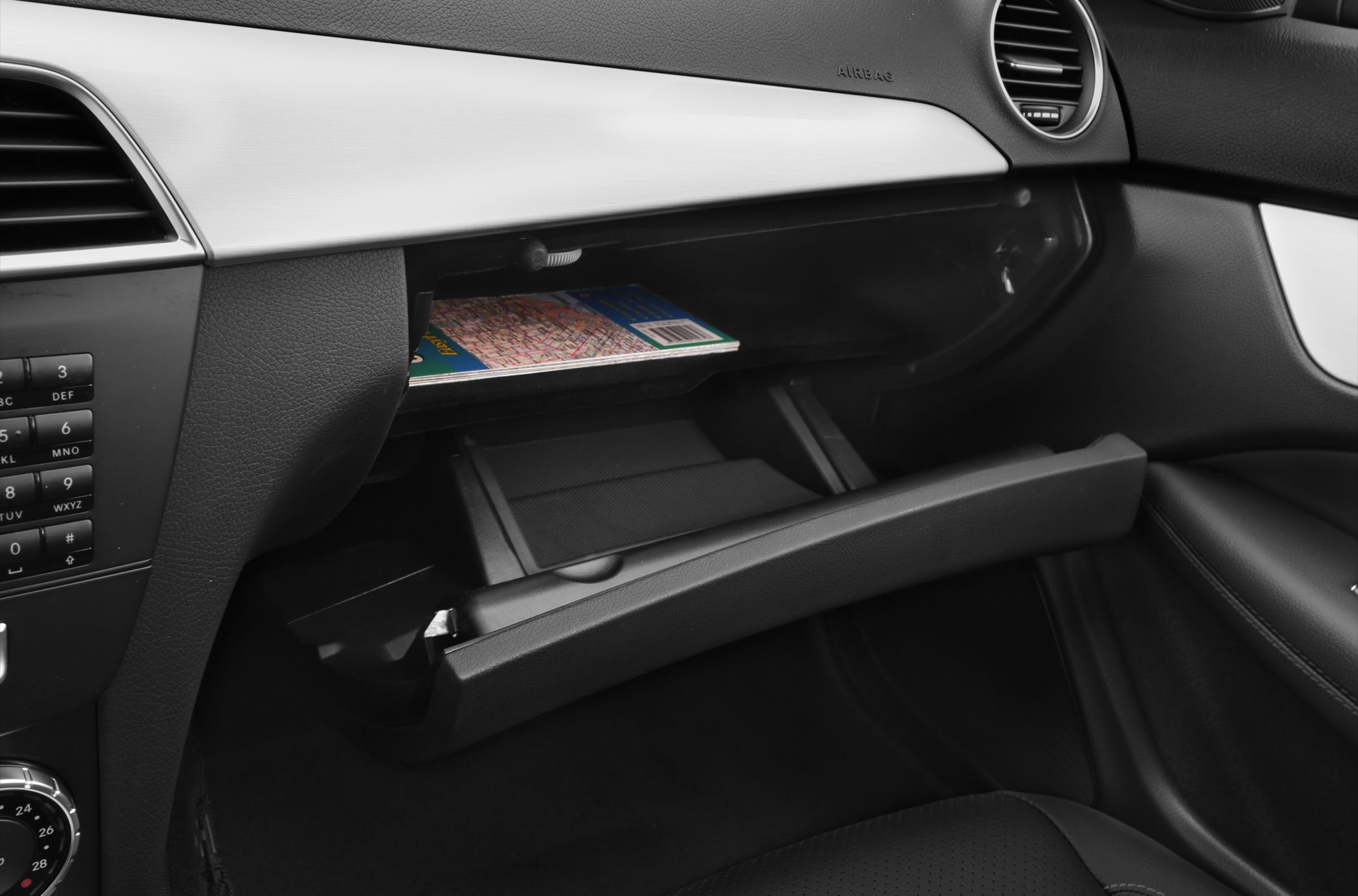 Open front passenger side glove box in modern car interior