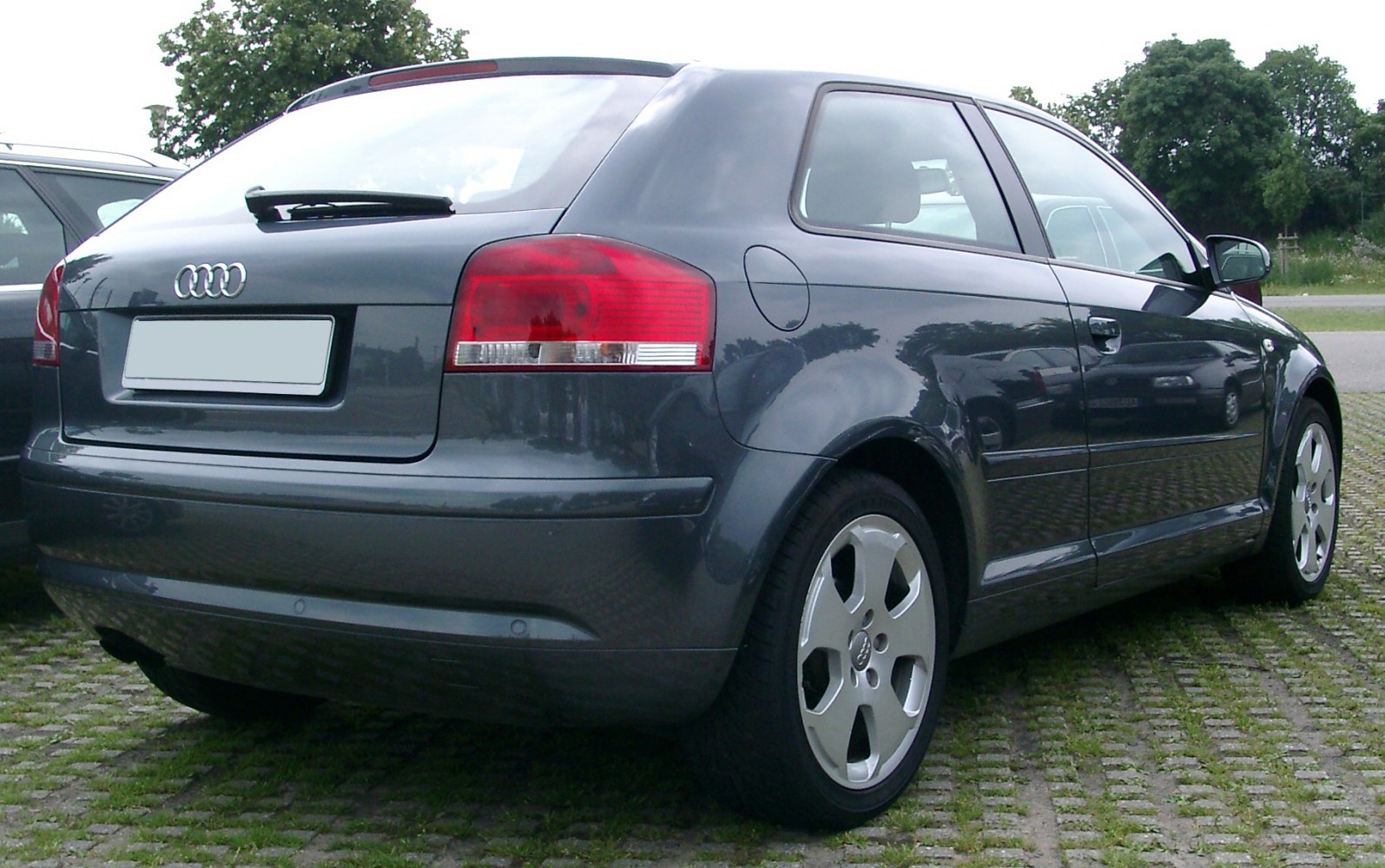 Rear view of hatchback with taillights and alloy wheels
