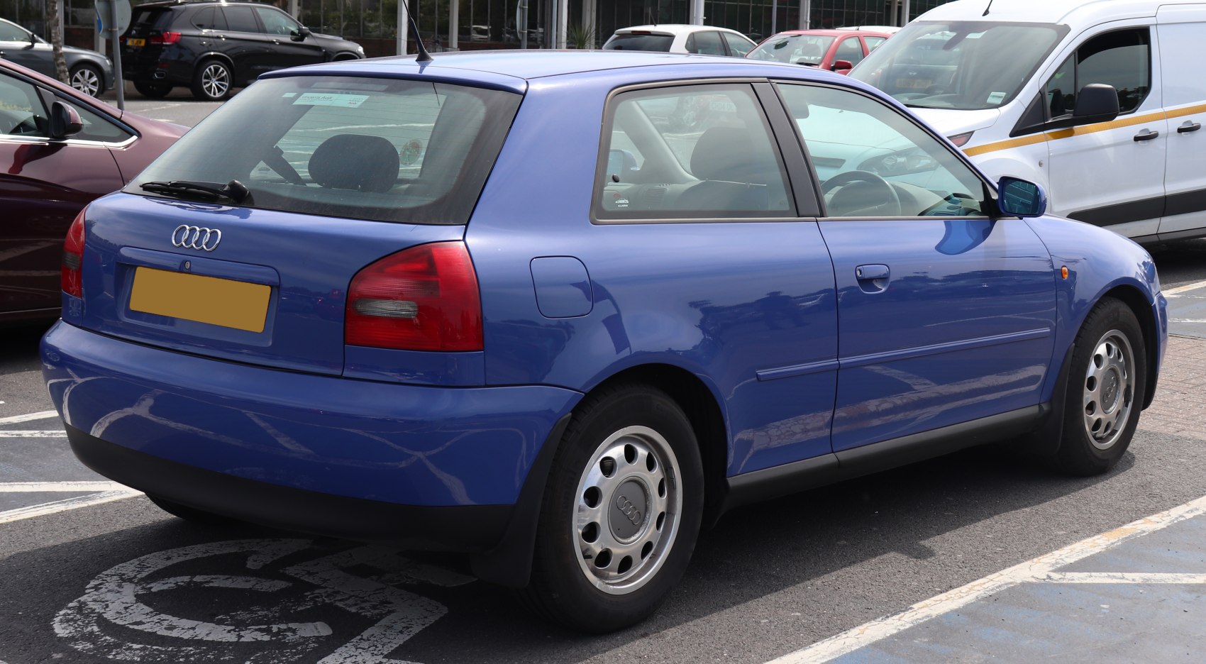 Distinctive rounded taillights and steel wheels on a compact hatchback.