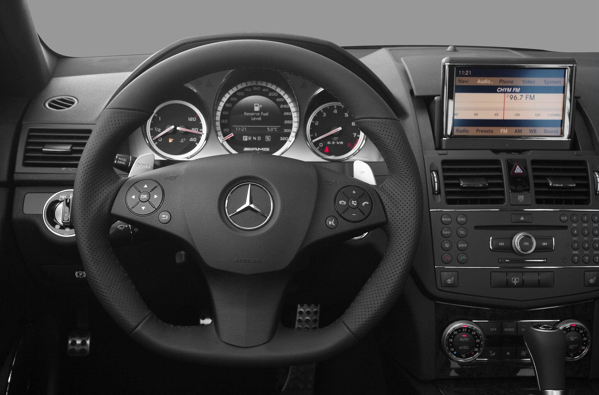 Steering wheel, instrument cluster, and infotainment display with dashboard controls.