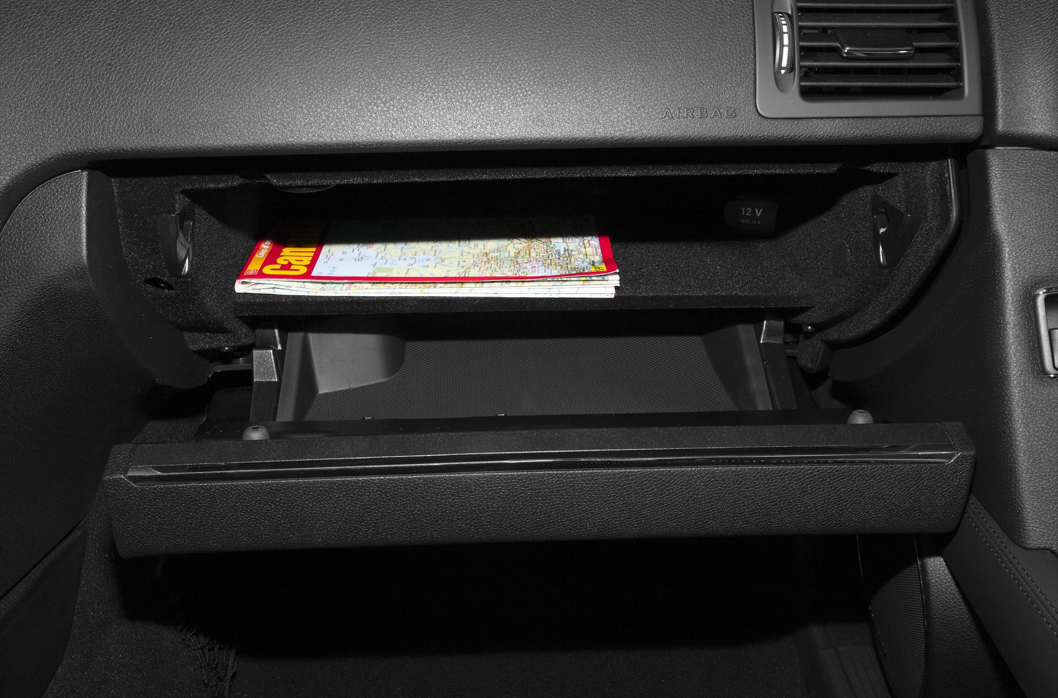 Open glove compartment with map and interior storage space