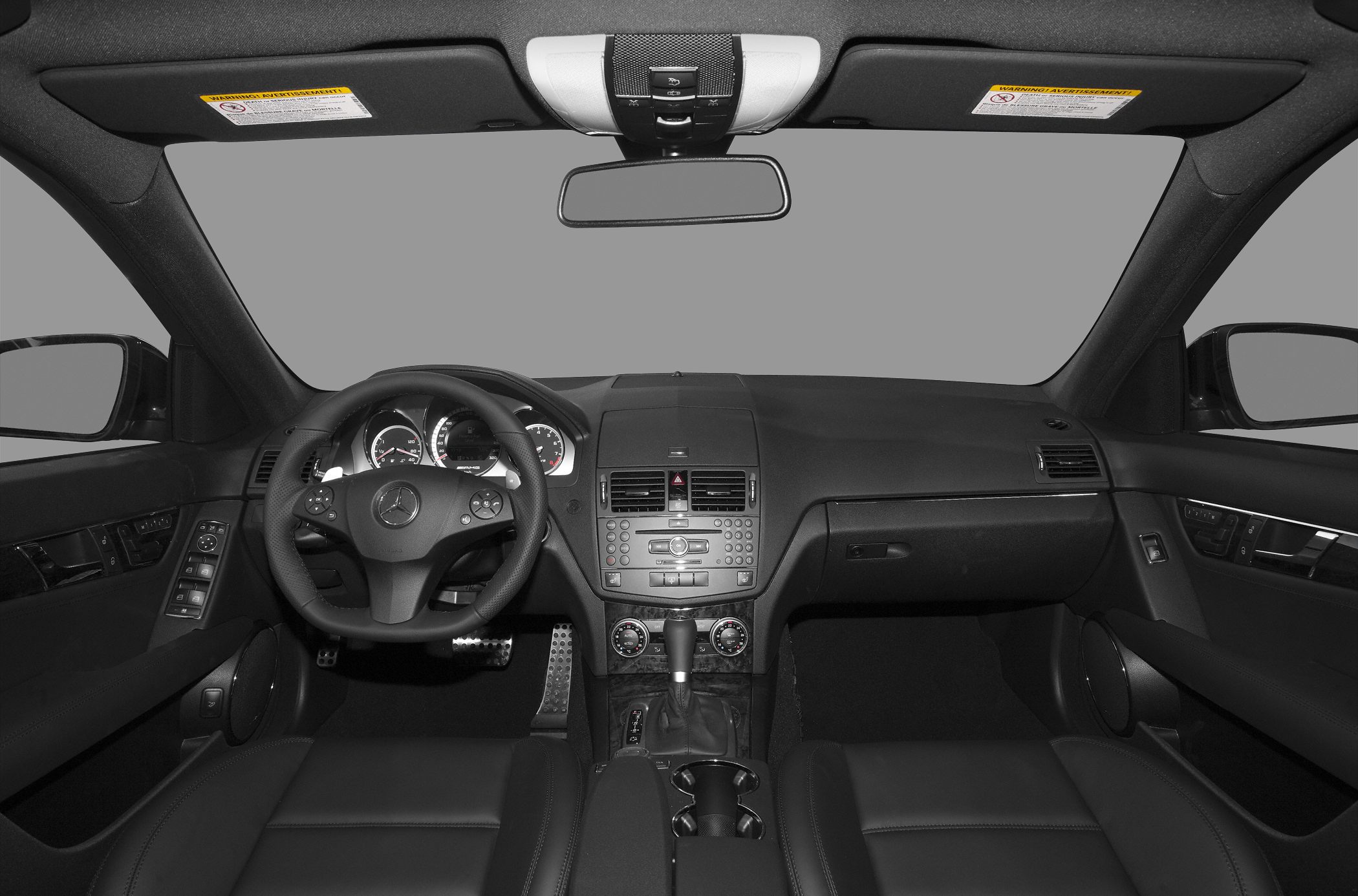 Dashboard and steering wheel interior of a luxury sedan.