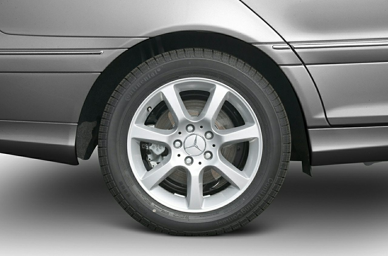 Silver alloy wheel with brake disc and Continental tire