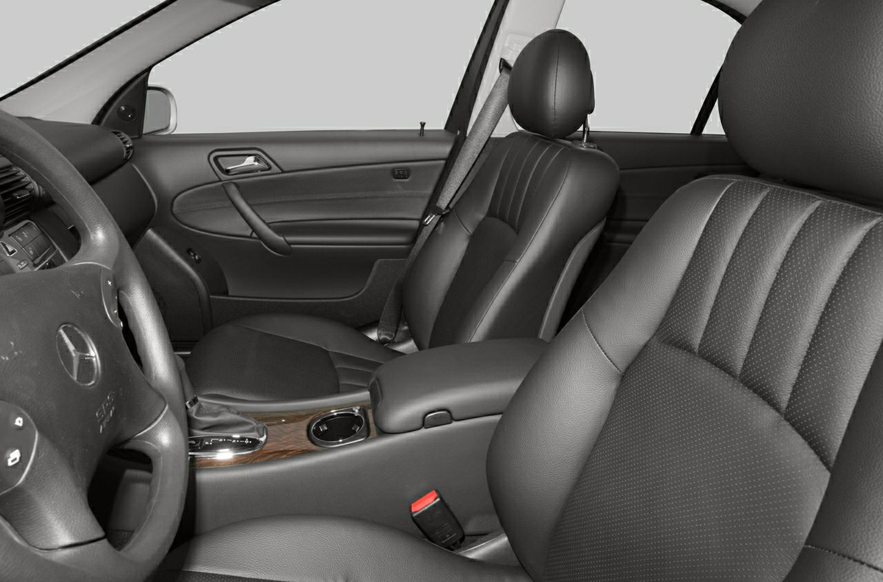 Leather seats and wood-trimmed center console in a car interior