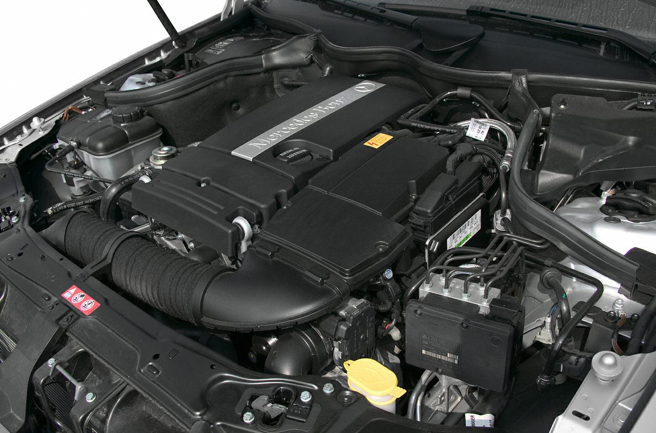 Engine bay with Mercedes-Benz branded engine cover and mechanical components