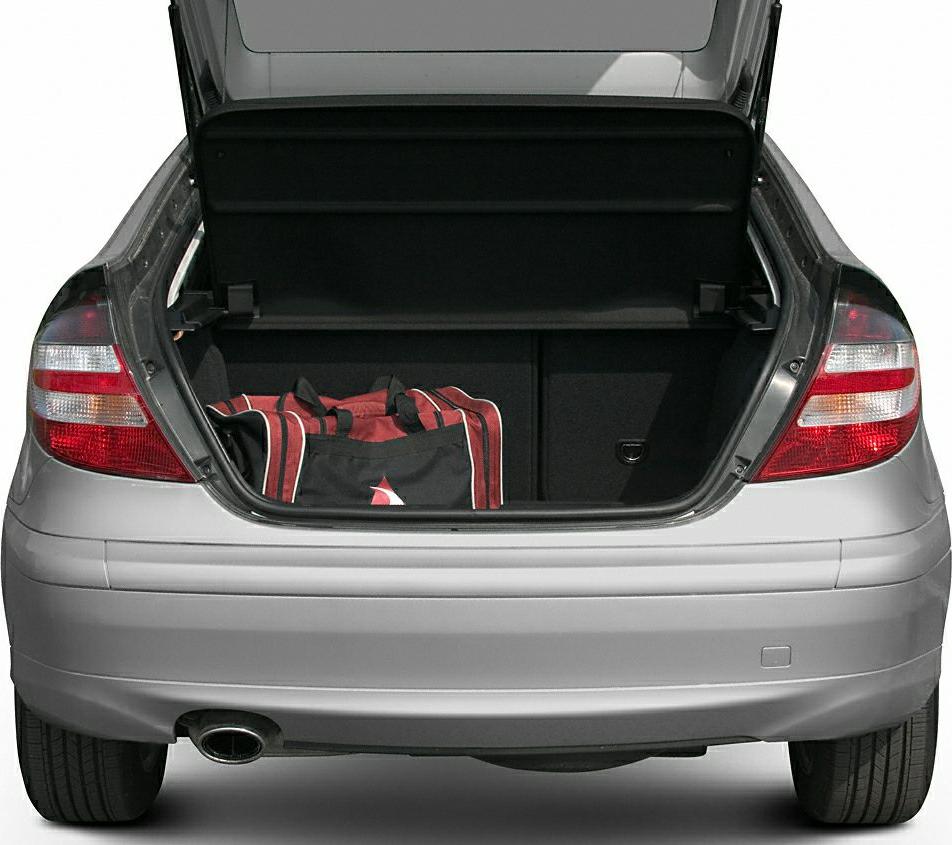 Open trunk with visible luggage, taillights, single exhaust