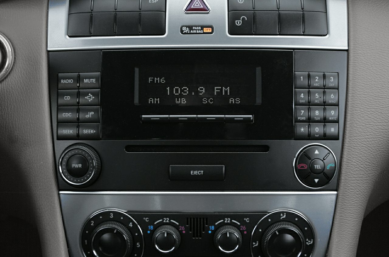 Classic car audio and climate control panel with buttons and dials