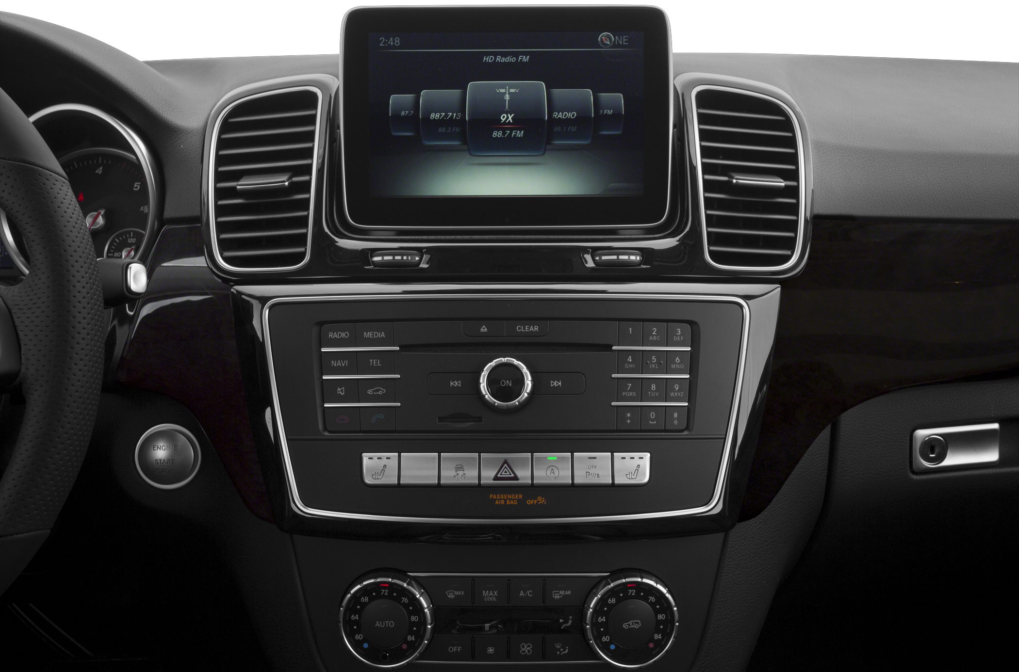 Infotainment screen and climate control panel with dials and buttons