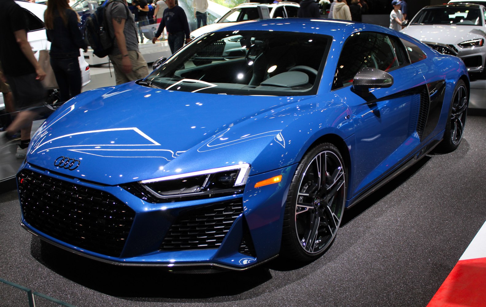 Blue sports coupe with LED headlights and side air intakes