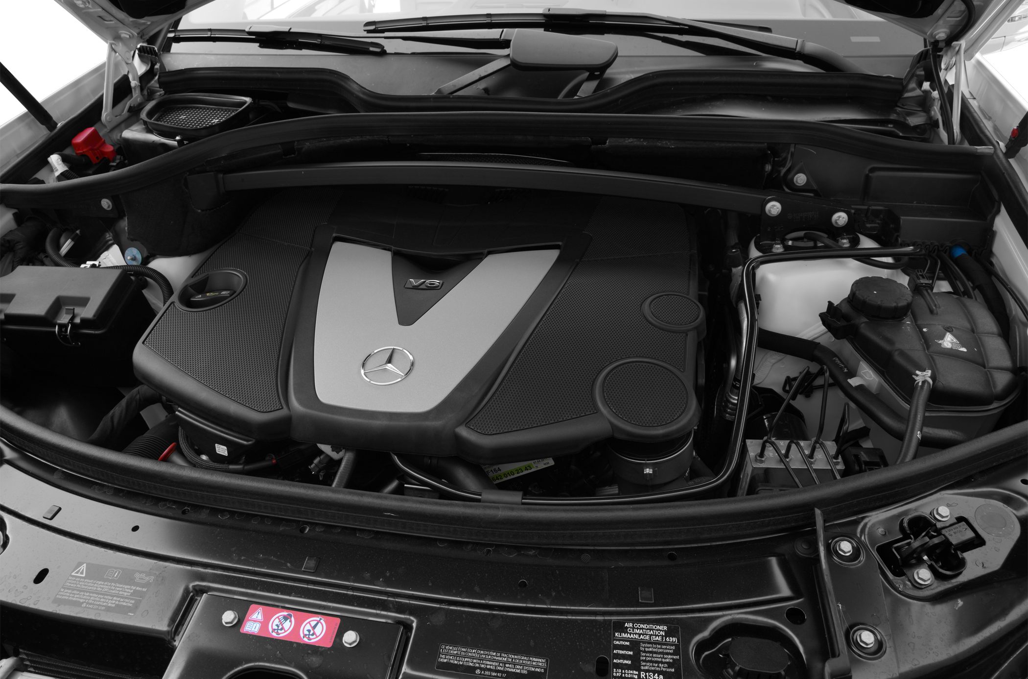 V6 engine with distinctive engine cover and adjacent components under hood