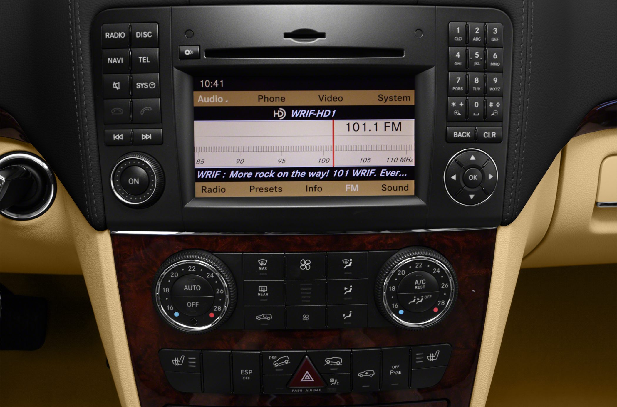 Center console infotainment and climate controls with dual-zone dials and radio display