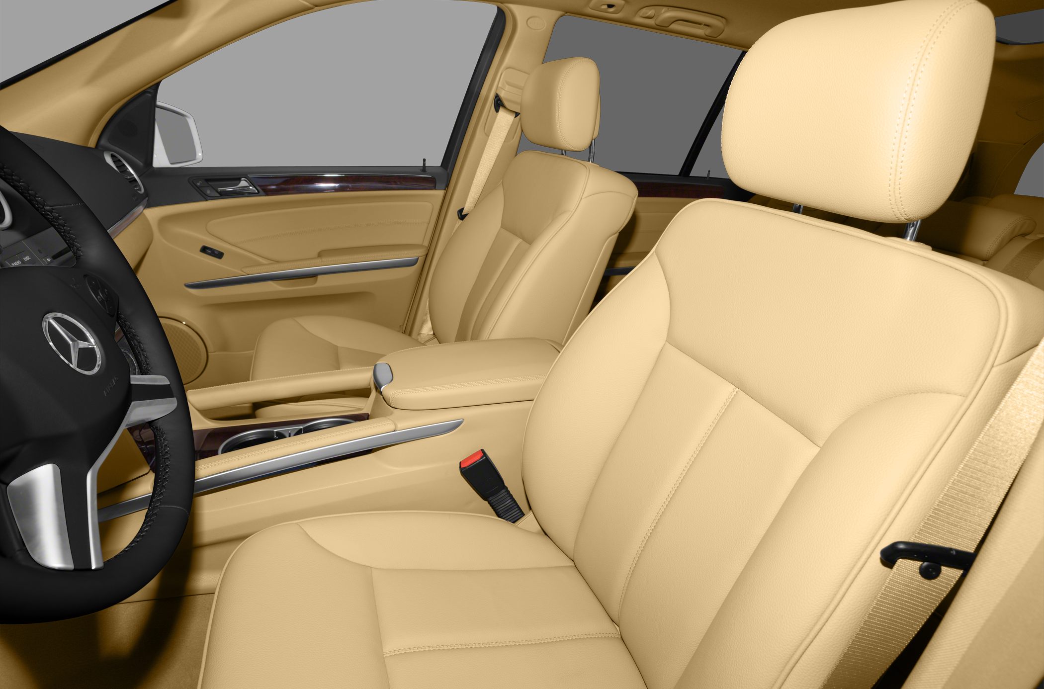 Beige leather front seats with wood trim and Mercedes steering wheel