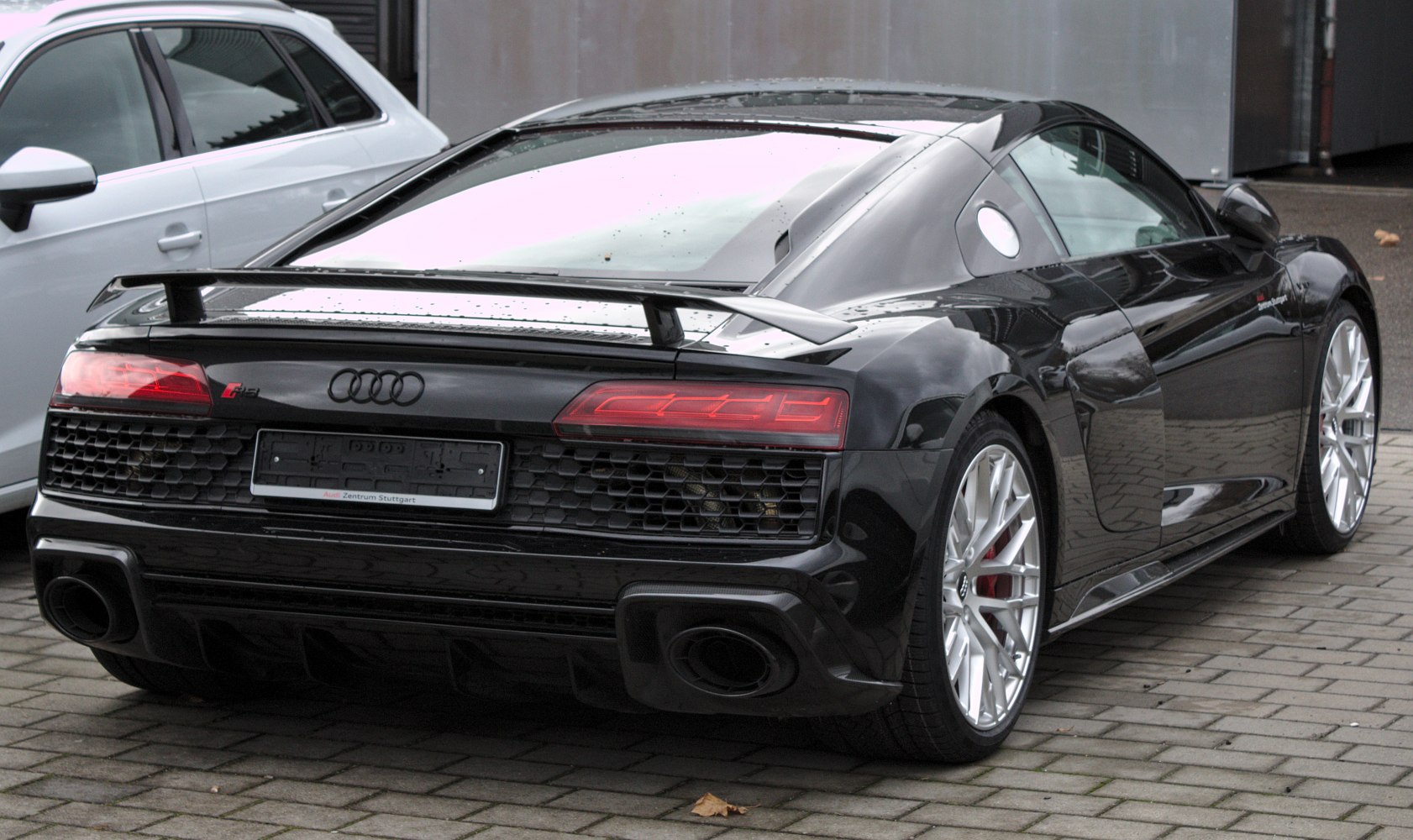 Rear view of a black sports coupe with spoiler and LED taillights