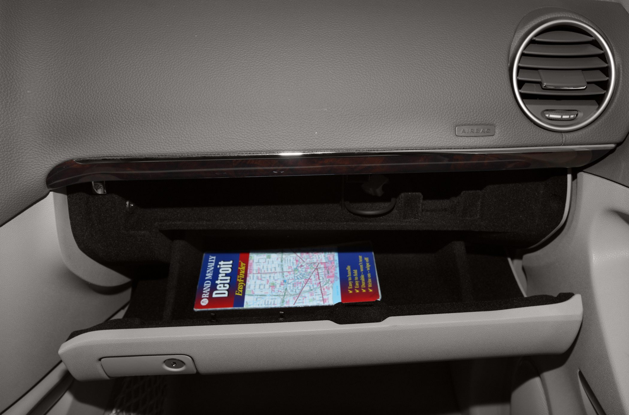 Open glove compartment with a Detroit map inside