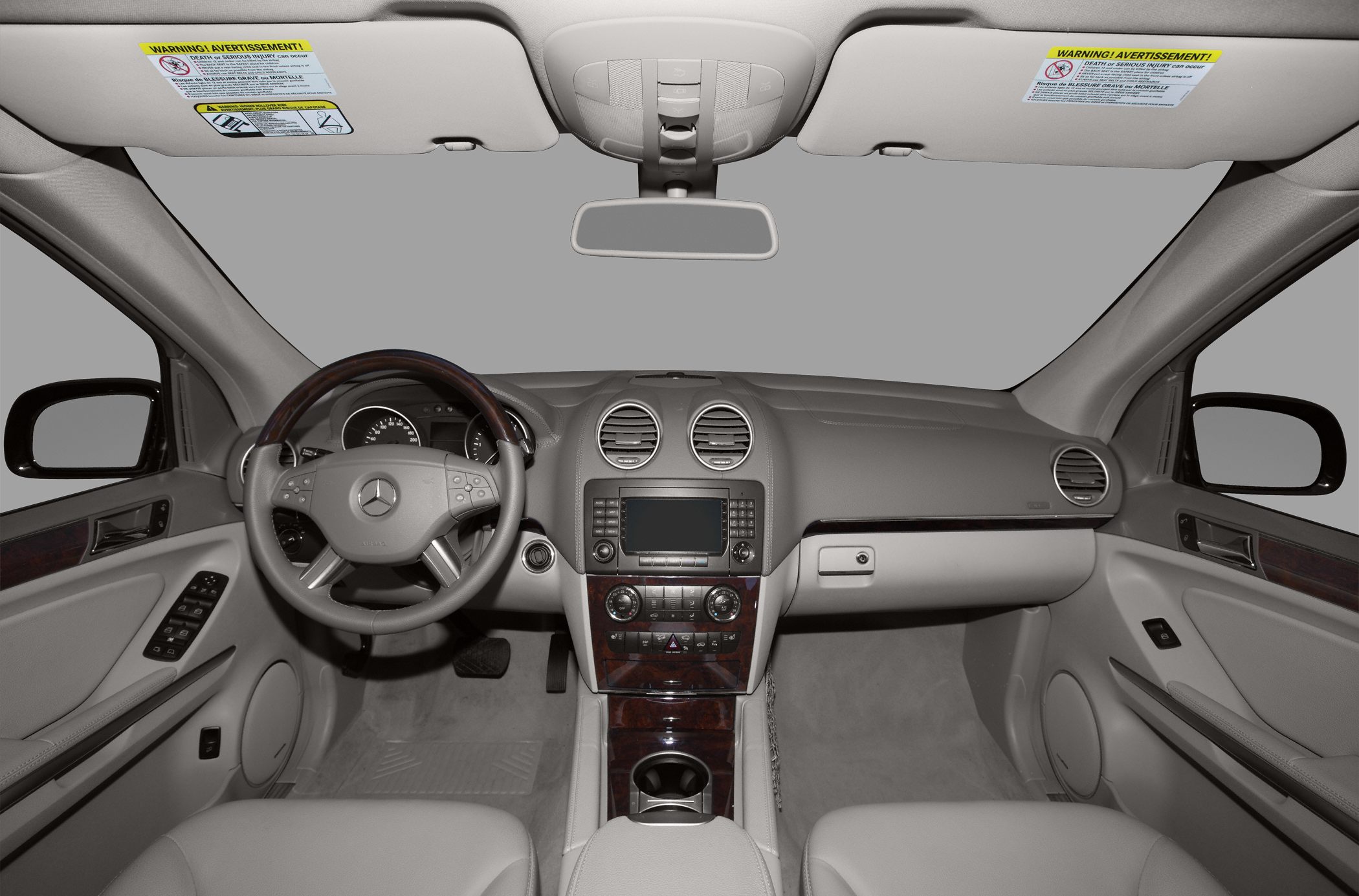 Dashboard and steering wheel with wood trim and dual air vents
