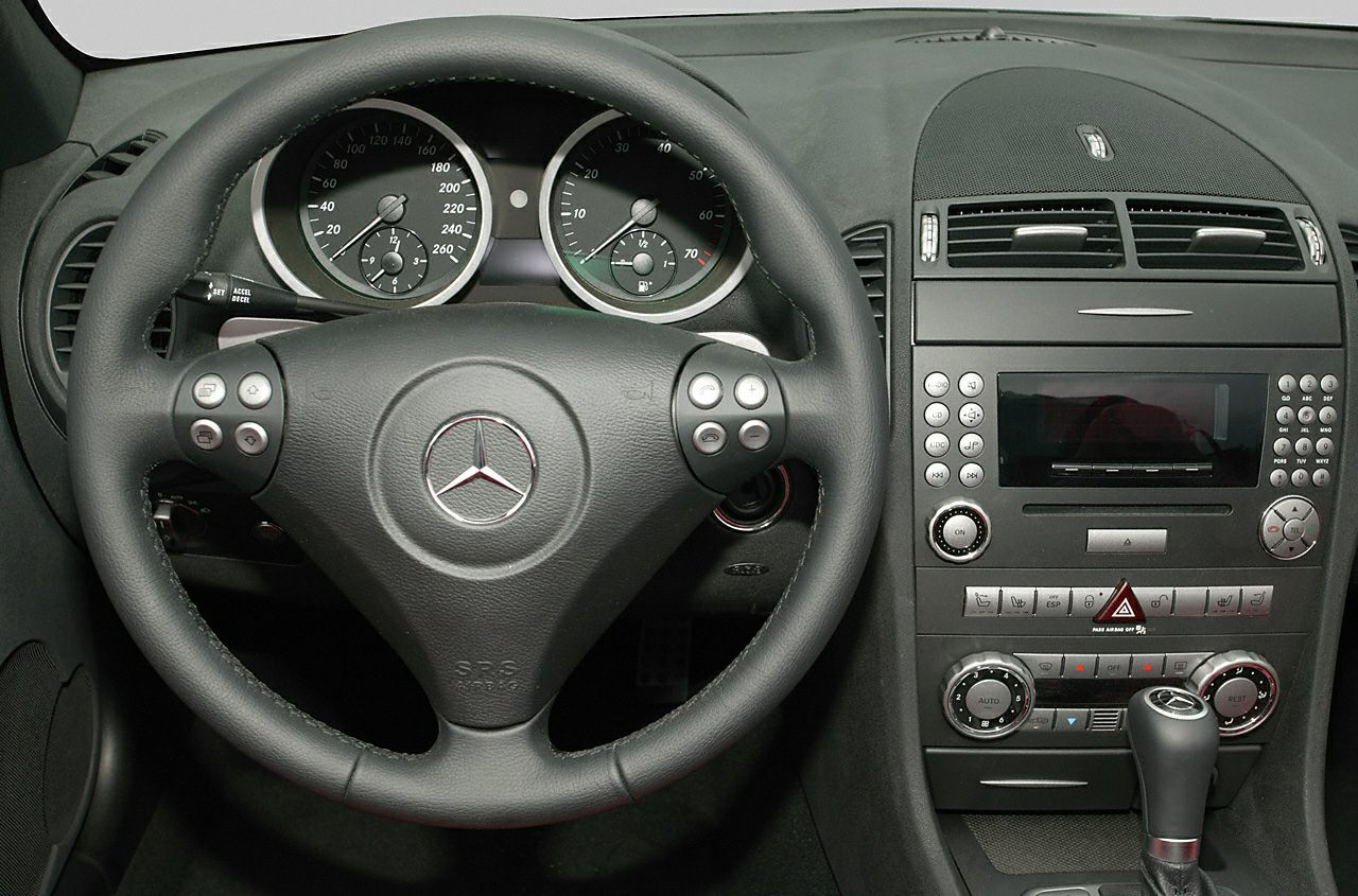 Steering wheel and dashboard with instrument cluster and center console.