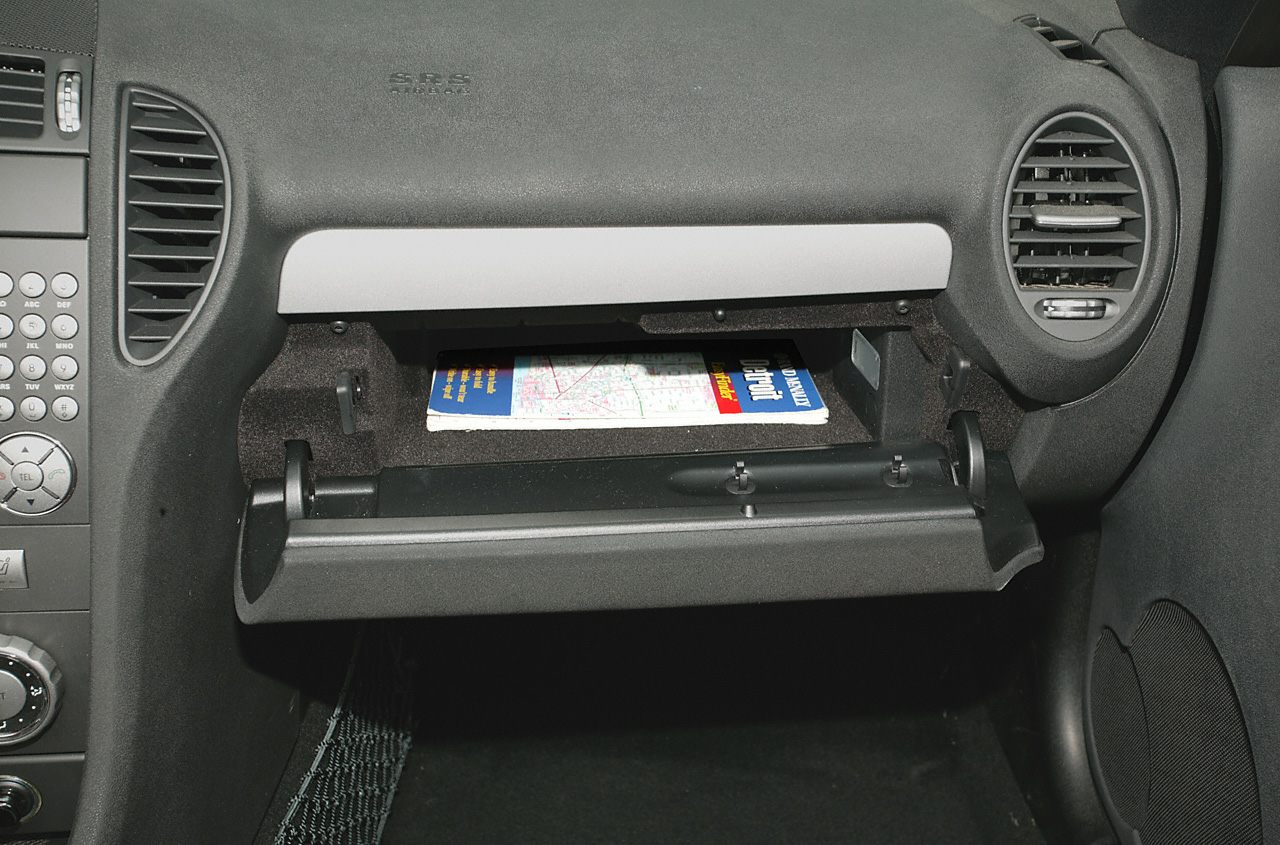 Car dashboard with open glove compartment and air vents