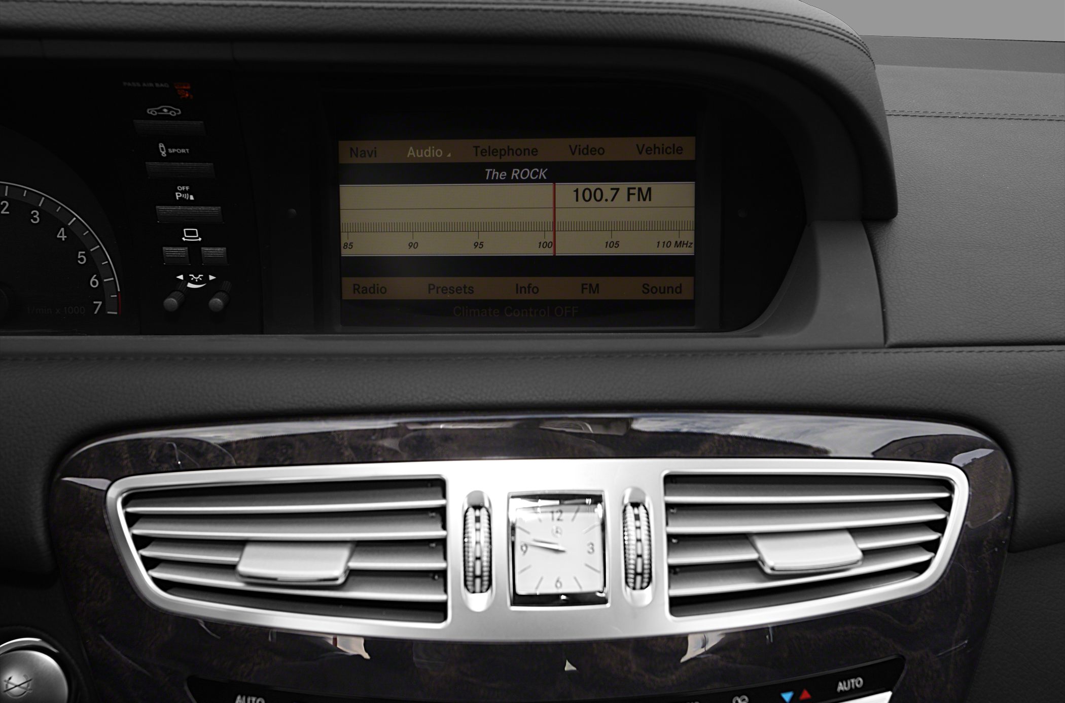 Car center console with analog clock and infotainment display