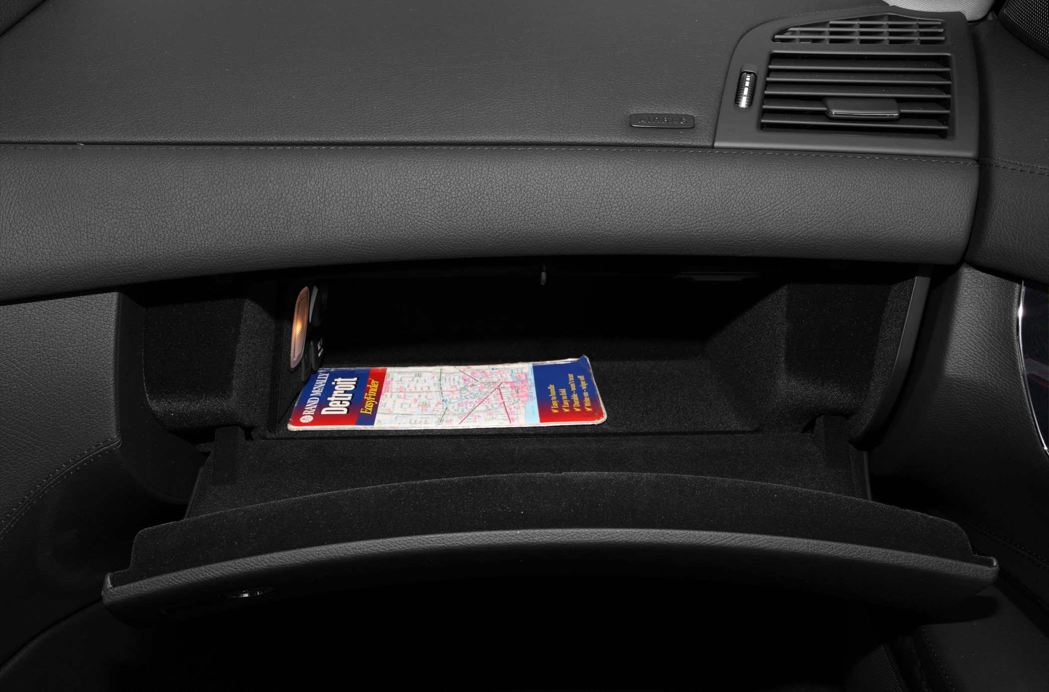 Glovebox interior with map and ambient light