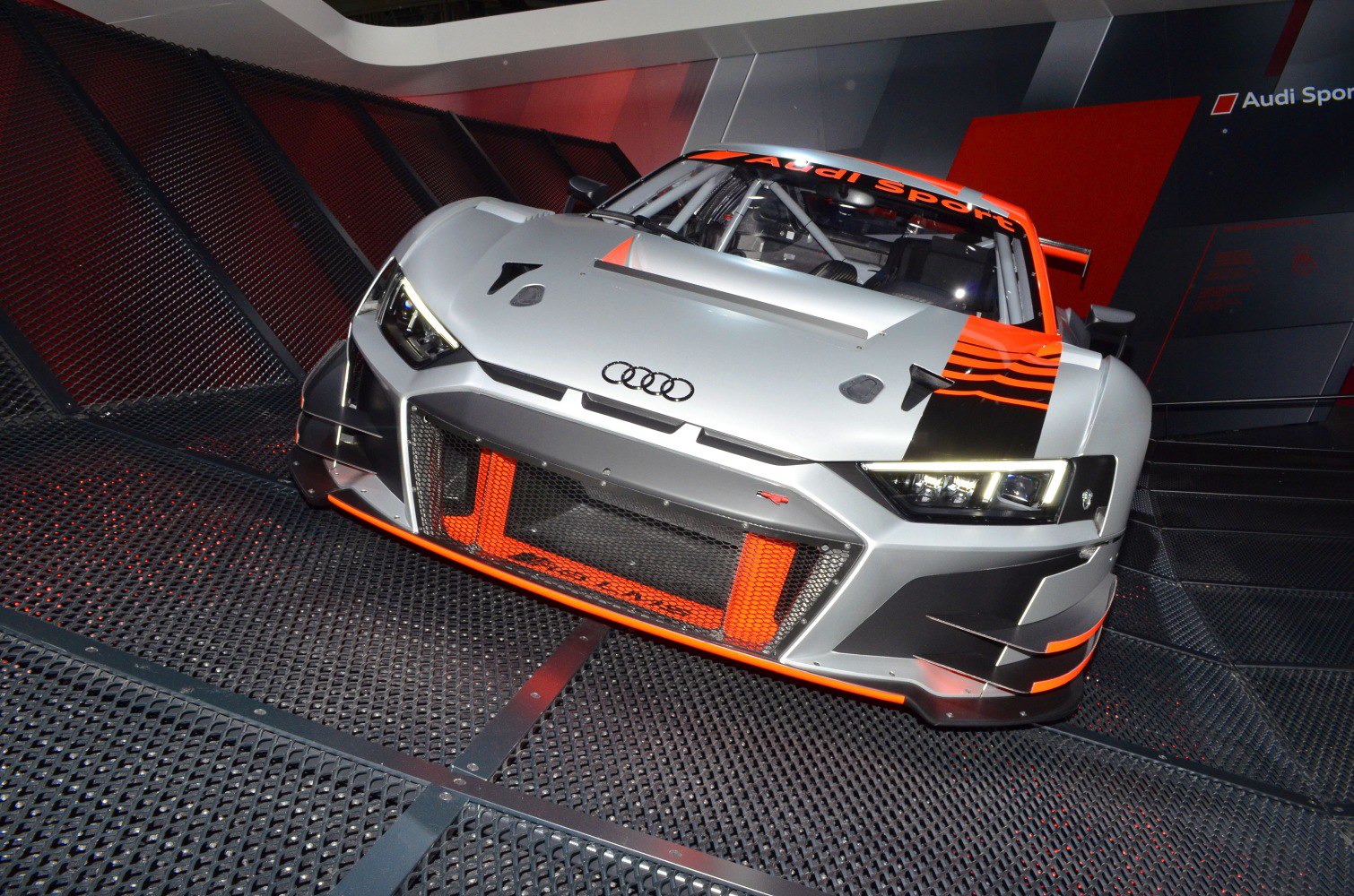 Front view of a racing car with aerodynamic design and LED headlights
