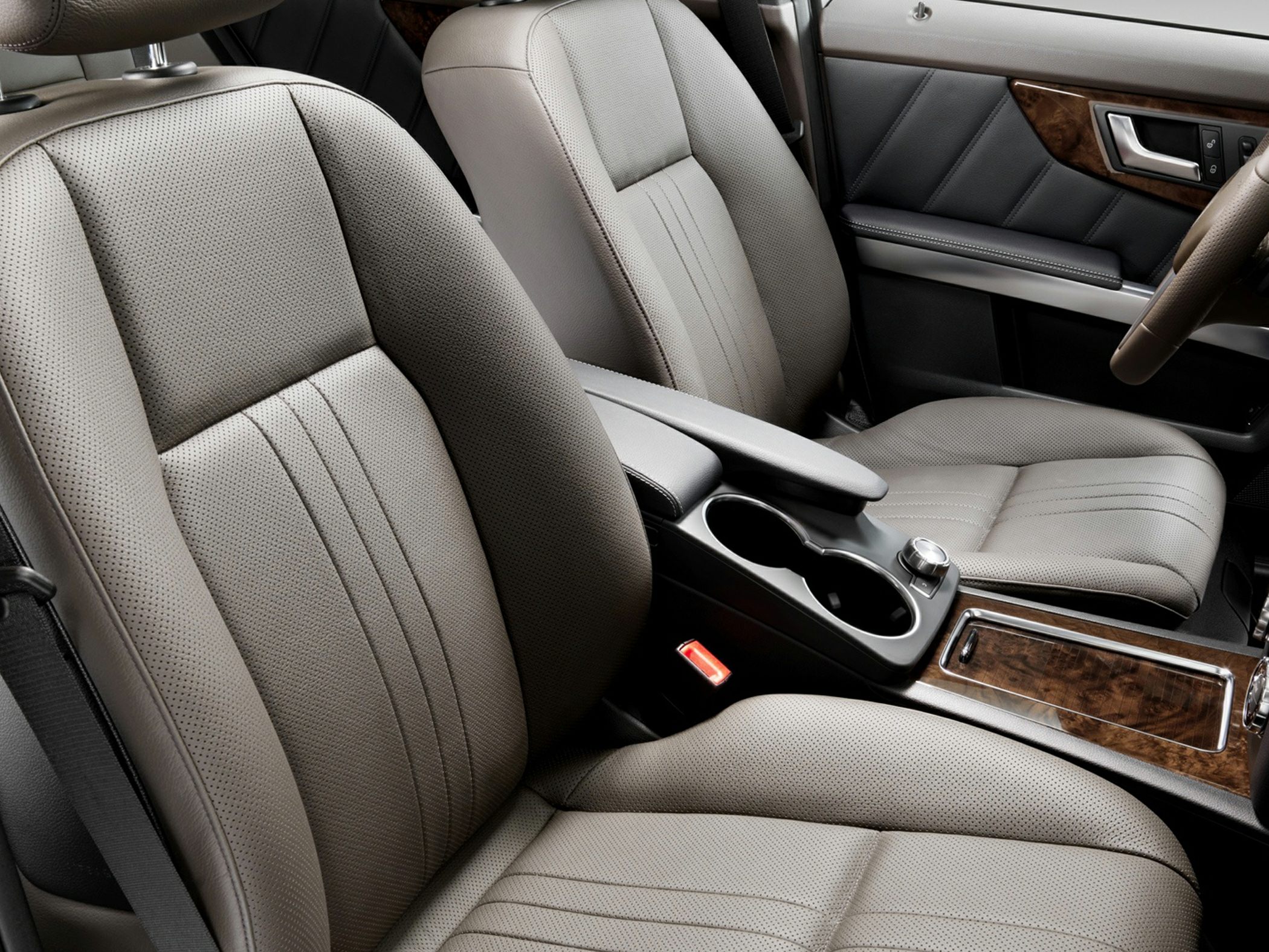 Perforated leather seats with wooden trim and center armrest console