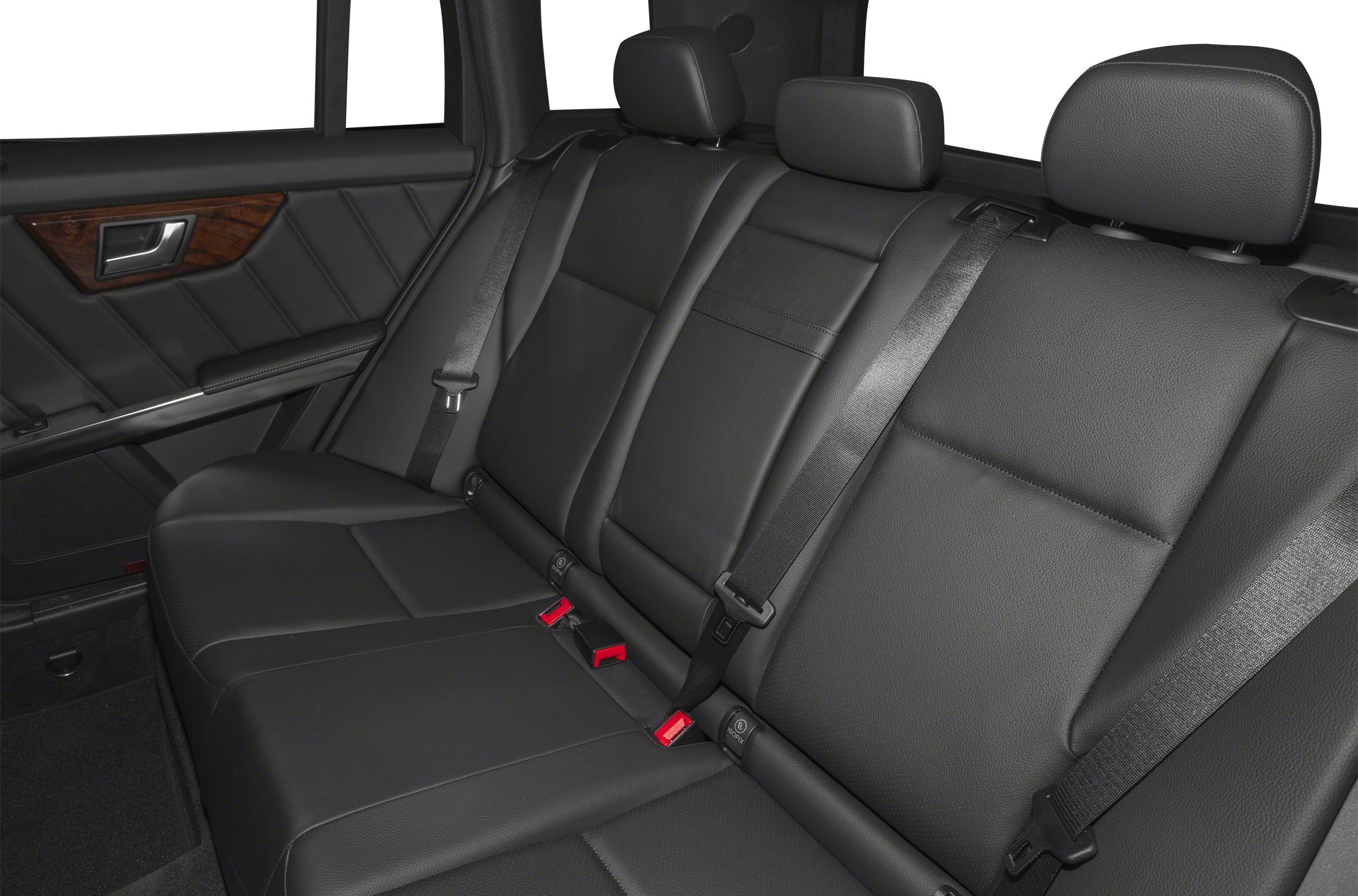 Black leather rear seats with headrests, seat belts, and wood trim on door.
