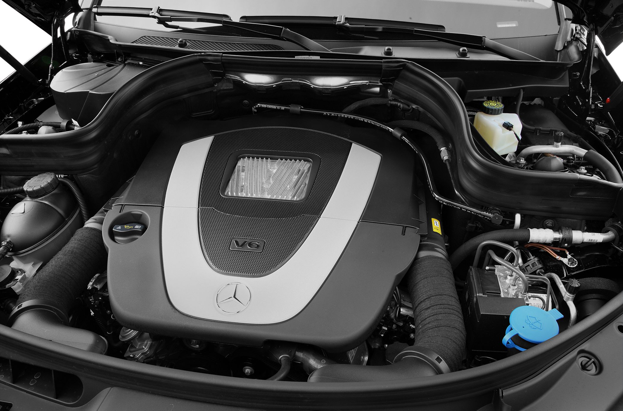 V6 engine compartment with engine cover and visible components