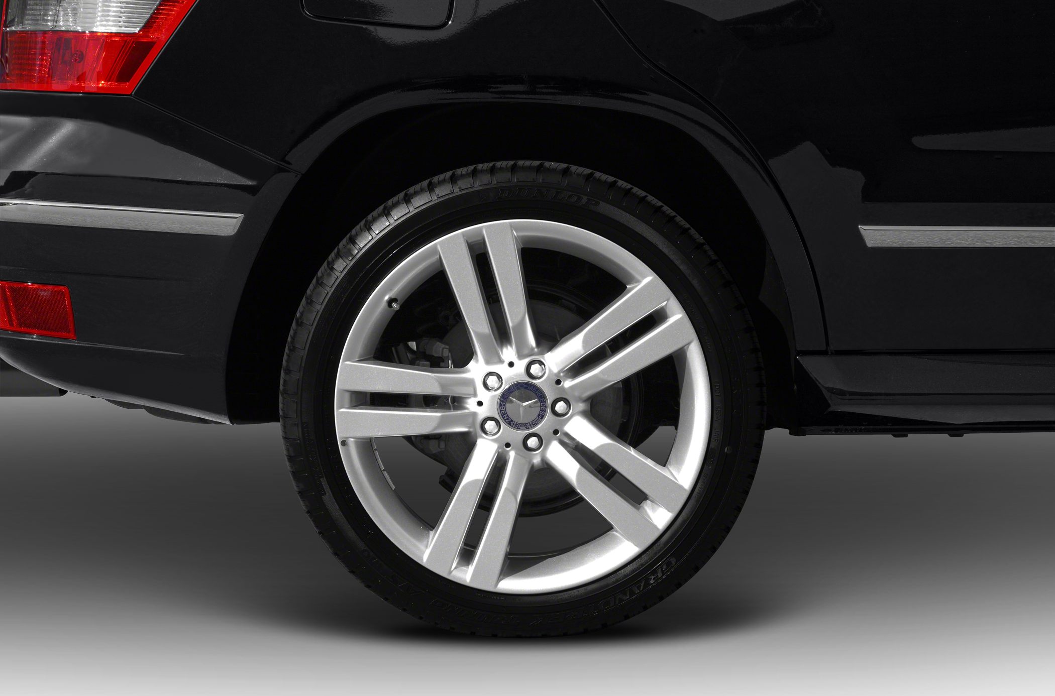 Silver multi-spoke alloy wheel and rear fender section with tire