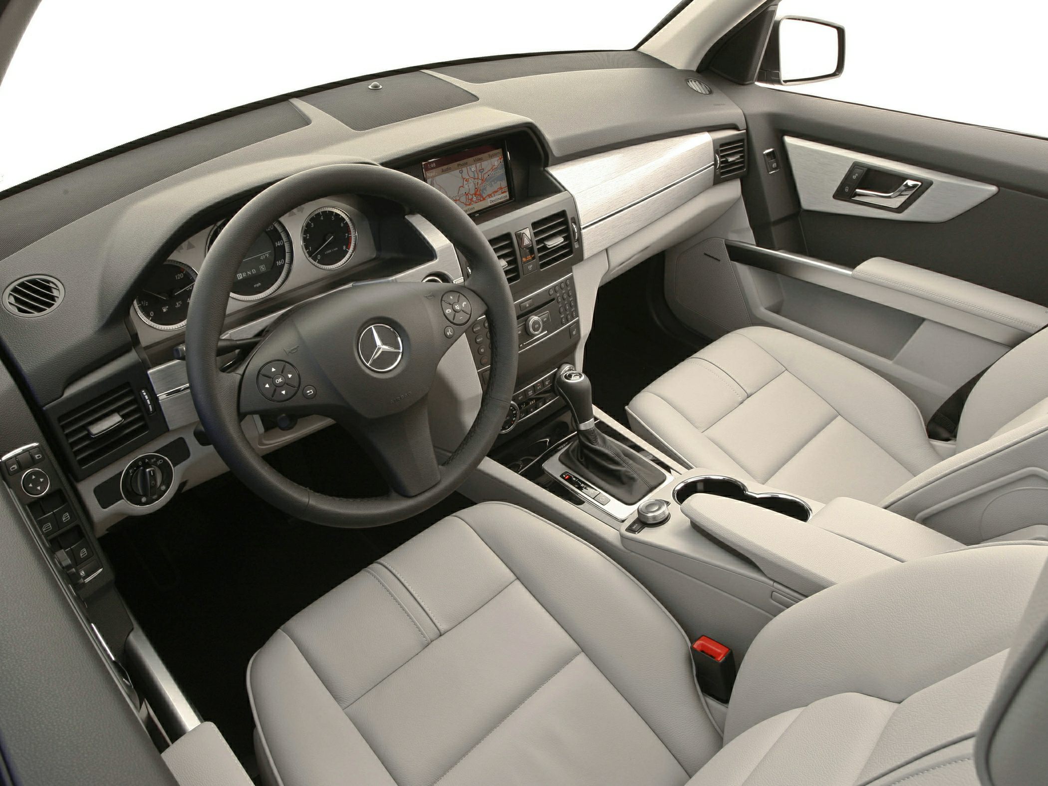 Dashboard layout with navigation screen and multi-function steering wheel