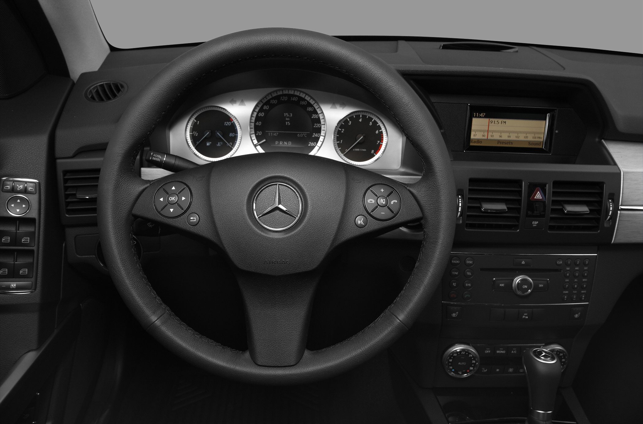 Steering wheel, instrument cluster, and central dashboard with controls and display