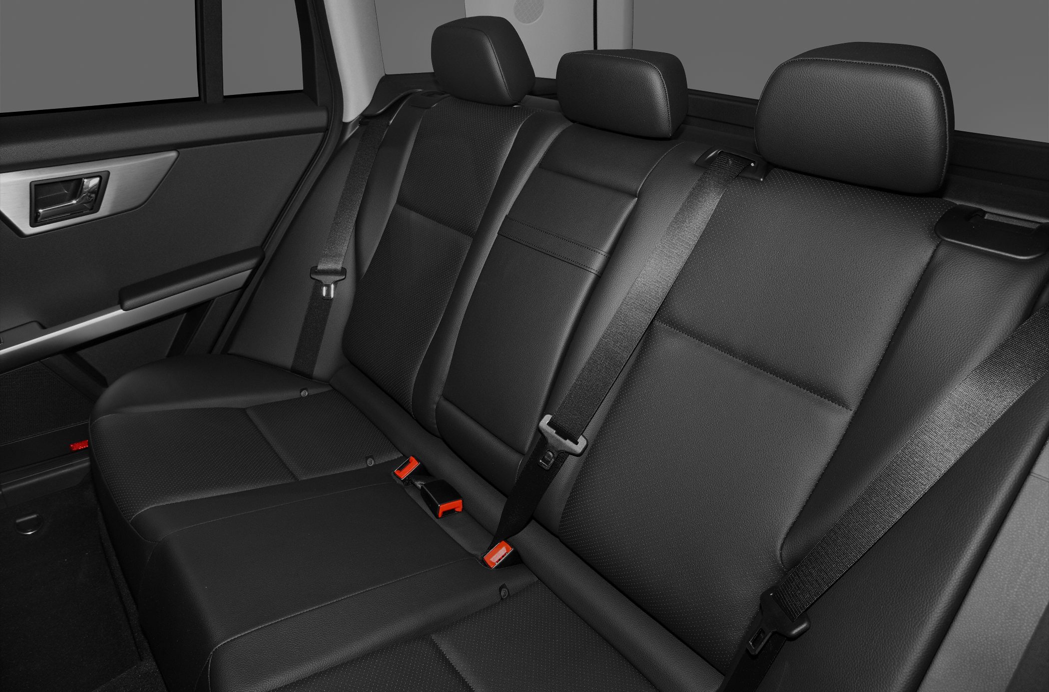Rear seat with black leather upholstery and seat belts