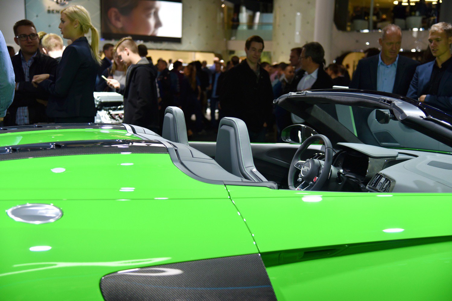 Convertible sports car with green exterior and two-seater interior