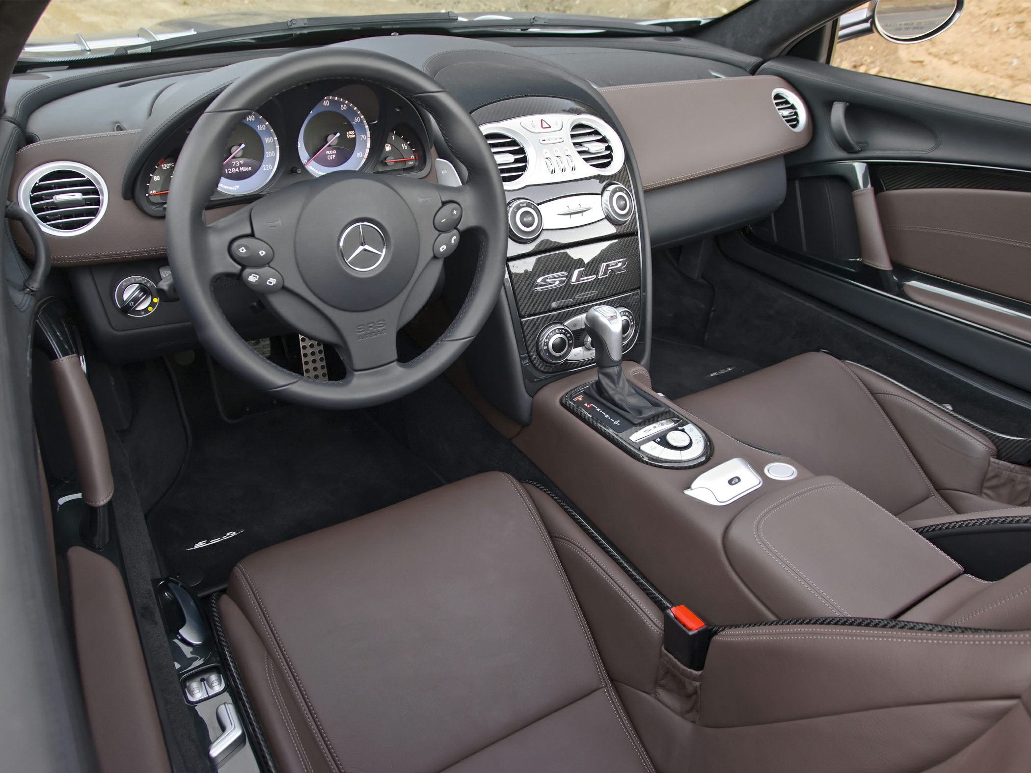 Luxury car interior with dashboard, steering wheel, and center console.