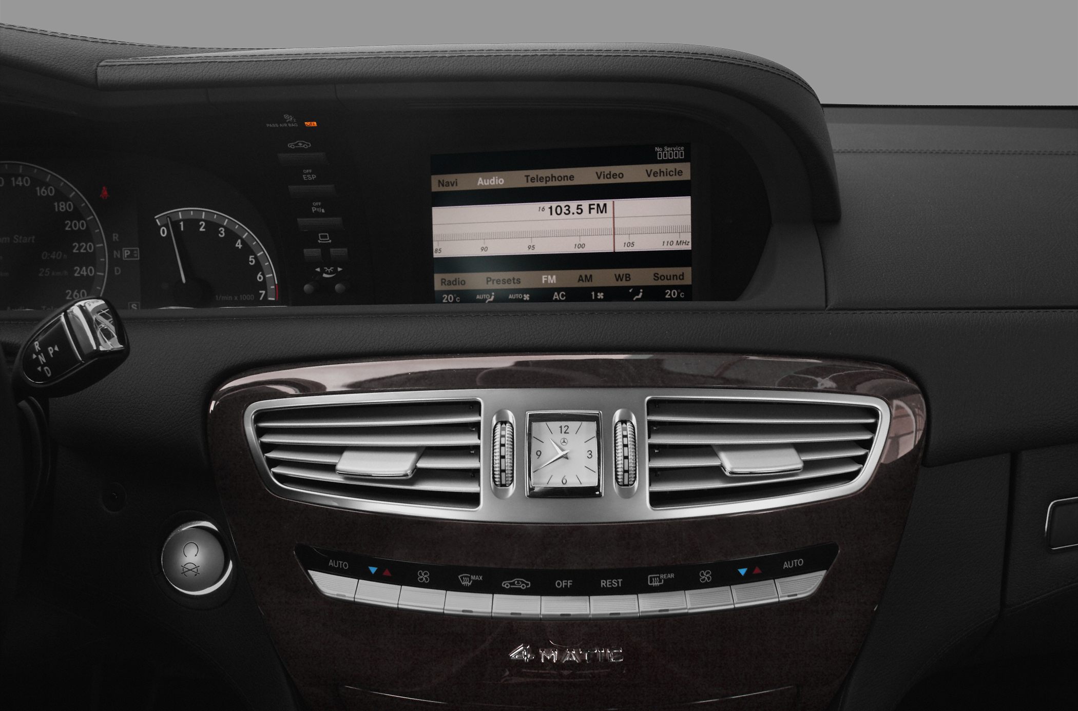 Dashboard with analog clock and infotainment screen