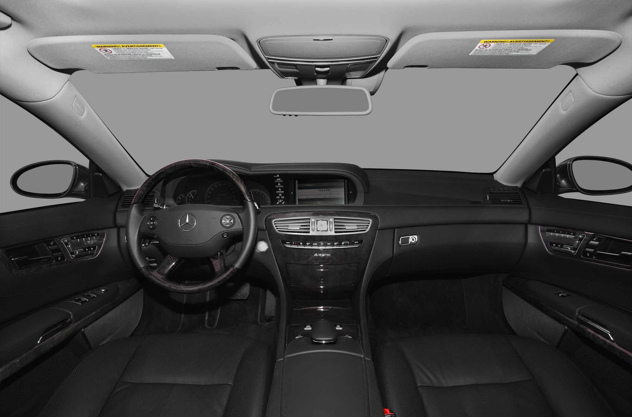 Interior dashboard and steering wheel with central console and dual sun visors
