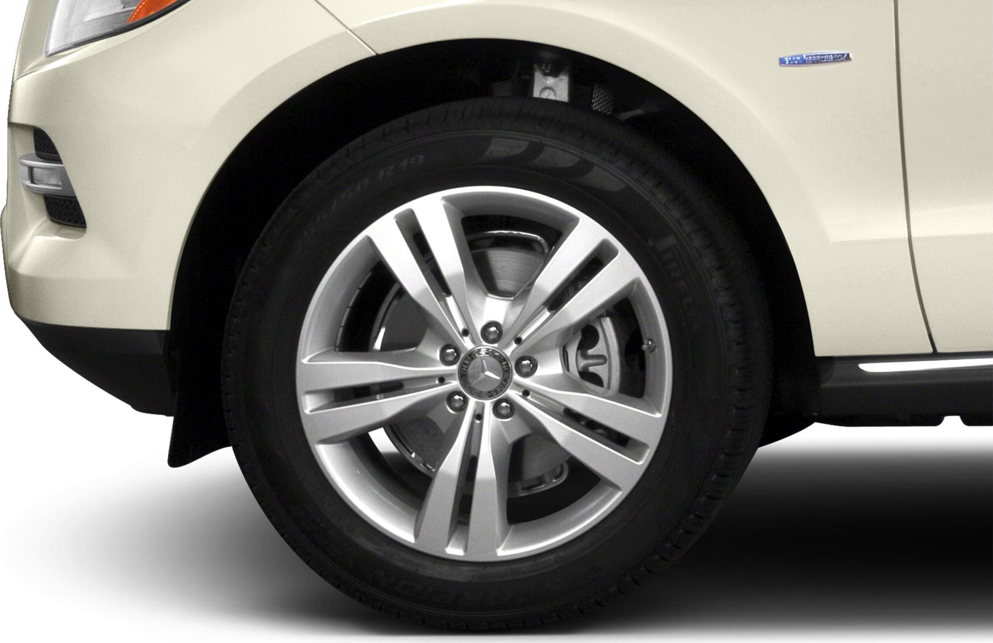 Front wheel with alloy rim and tire on SUV.