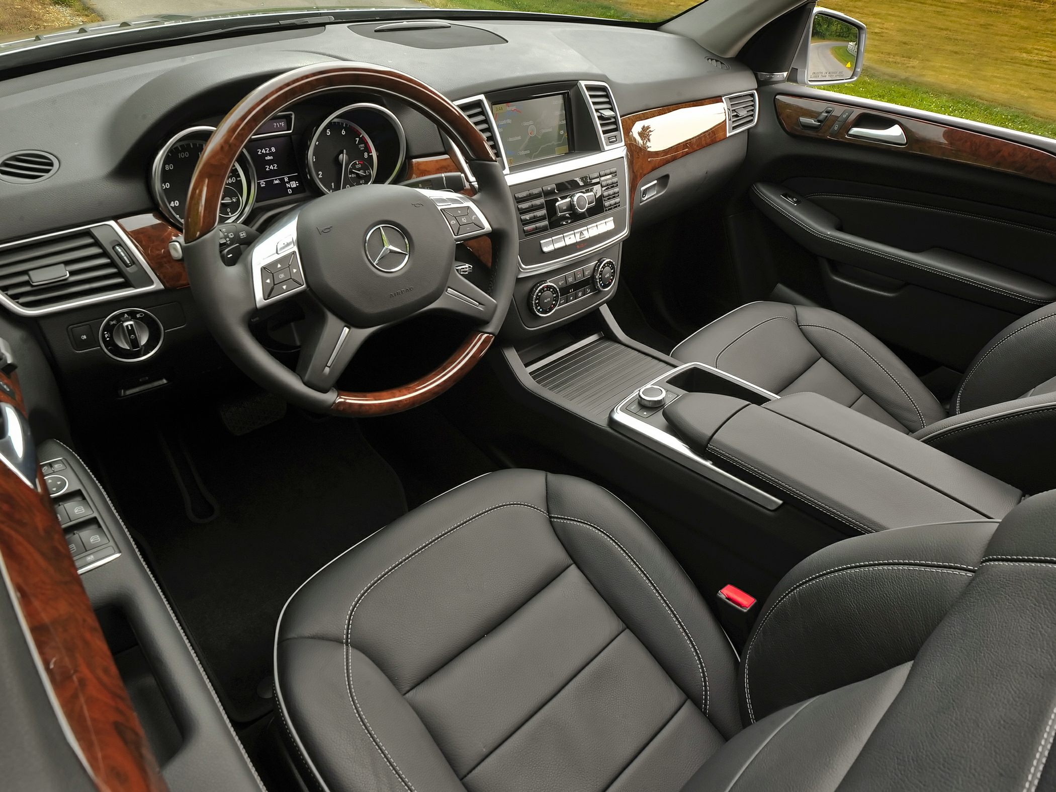 Wood-trimmed steering wheel, infotainment console, leather seats