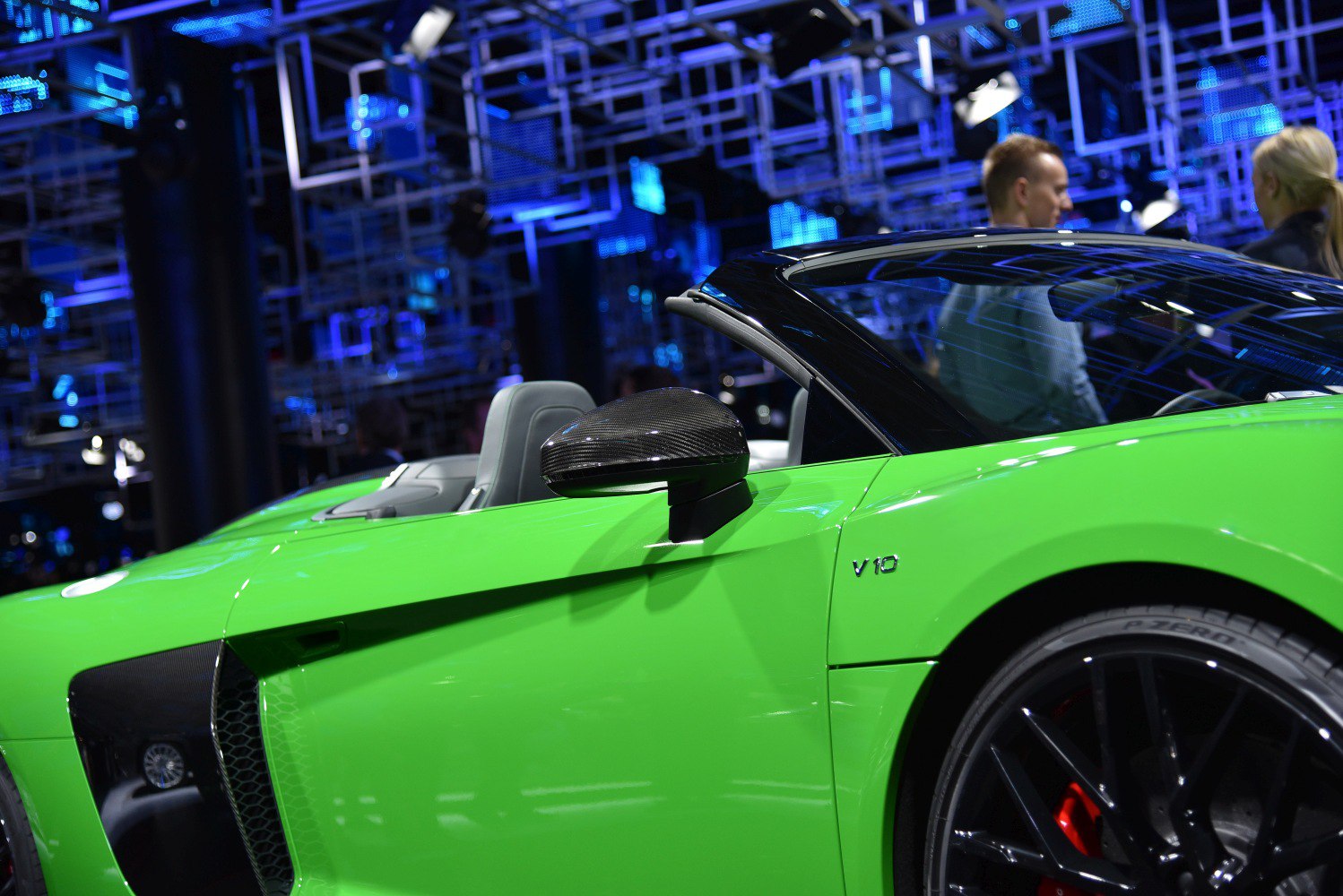 Green sports car side with V10 badge and carbon mirror